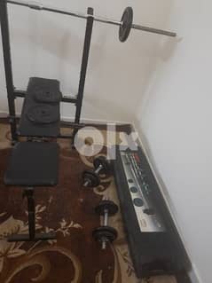 used home jym straight bar dumbal and plates for sale 0