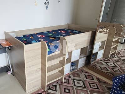 slightly used kid bunk bed with book storage