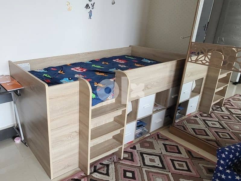 slightly used kid bunk bed with book storage 0