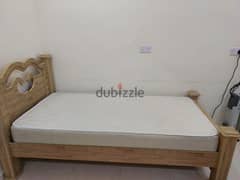 Wooden bed with mattress