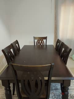 A dinig table with six chairs in a very good condition 45 BHD