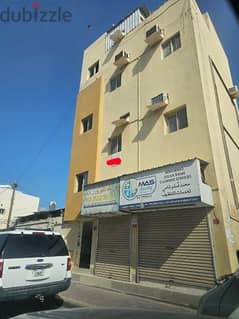 shop in Moharraq market main road and flat with ewa