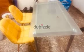 glass table with two chairs