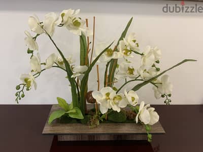 Artificial orchid with wooden vase