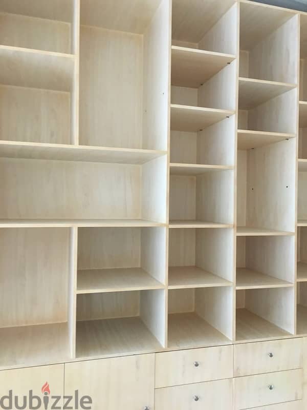 beige wood shelves and cupboards for shop 9