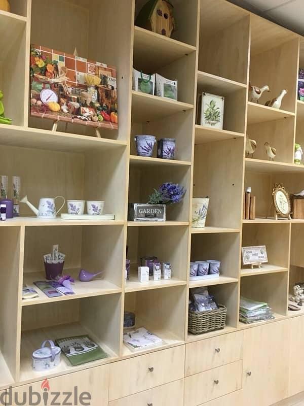 beige wood shelves and cupboards for shop 13