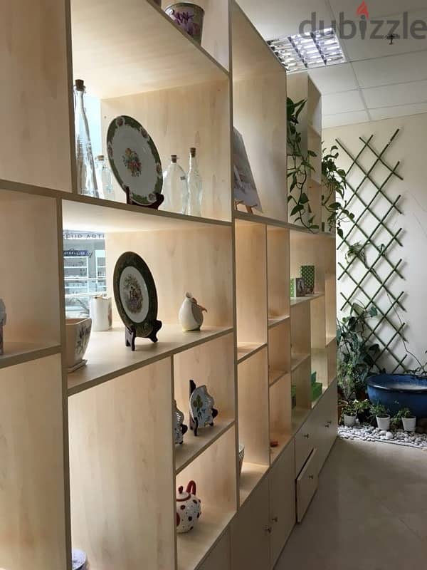 beige wood shelves and cupboards for shop 14