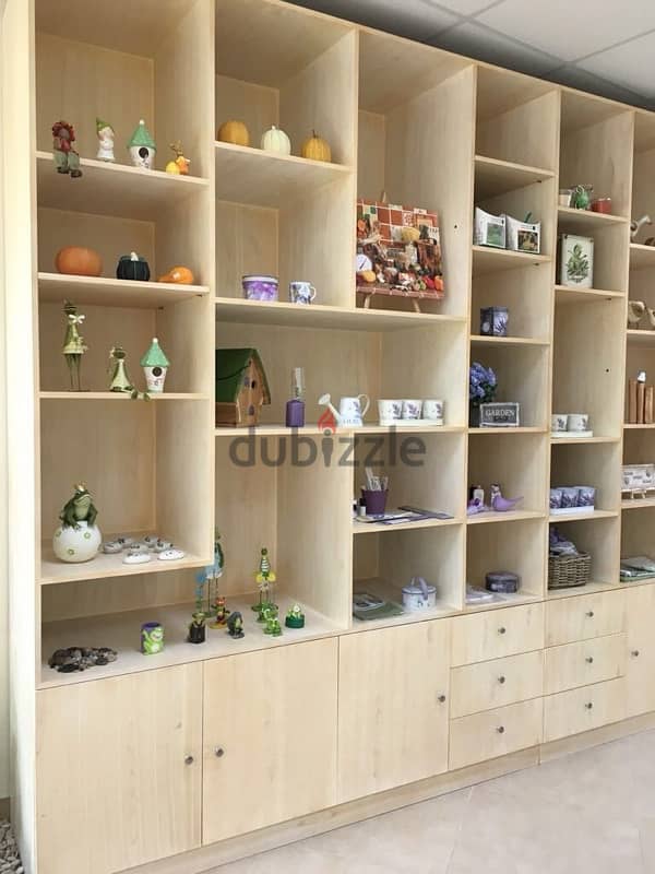 beige wood shelves and cupboards for shop 15