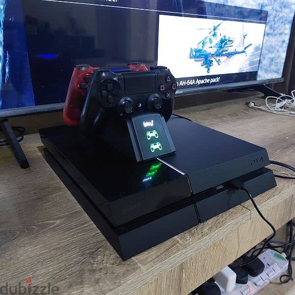 PS4 1TB with 2 controllers, charging stations, and 1 CD 2