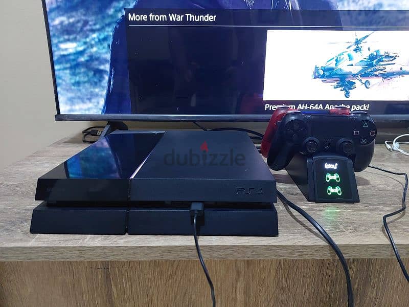 PS4 1TB with 2 controllers, charging stations, and 1 CD 3