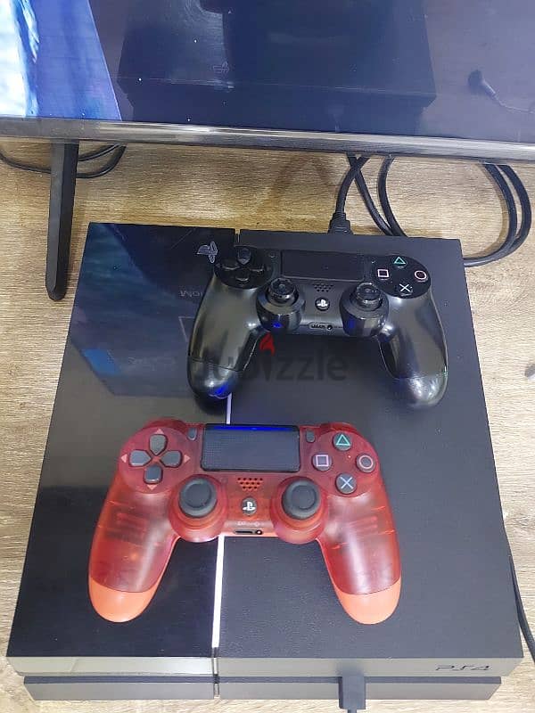 PS4 1TB with 2 controllers, charging stations, and 1 CD 5