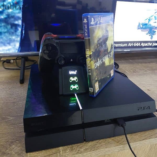 PS4 1TB with 2 controllers, charging stations, and 1 CD 6