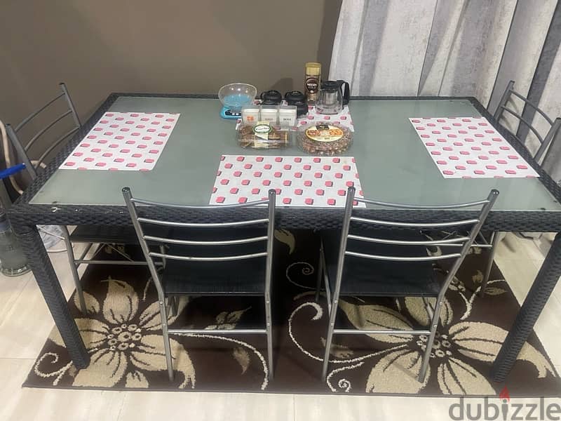 glass dinning table with 4 chairs from Marina 1