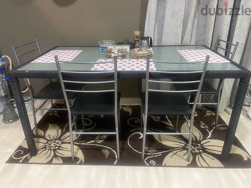 glass dinning table with 4 chairs from Marina 2