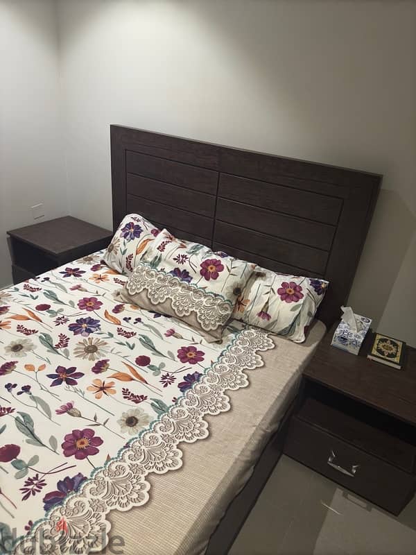 Double-sized wooden bed Includes 2 bedside tables. 1