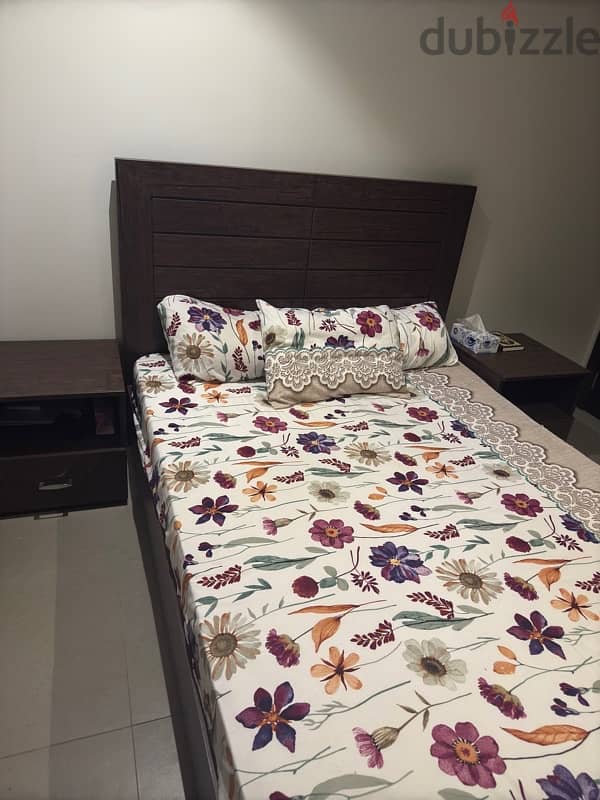 Double-sized wooden bed Includes 2 bedside tables. 2