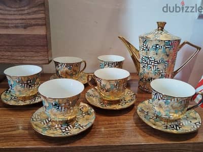 a beautiful golden tea set just like new only 1 cup slightly chipped .