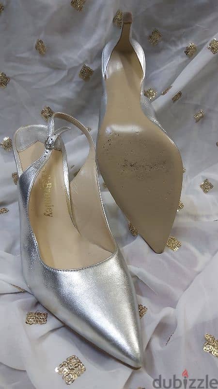 Preowned Russell & bromley silver sling back heels. Size  39.5. 25BD 1