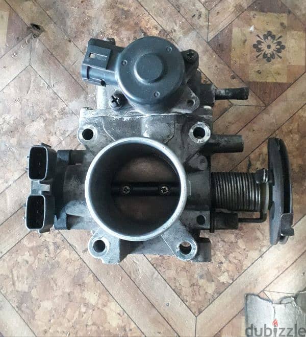 Nissan sunny 2004 throttle body very good condition contact= 39391654 1