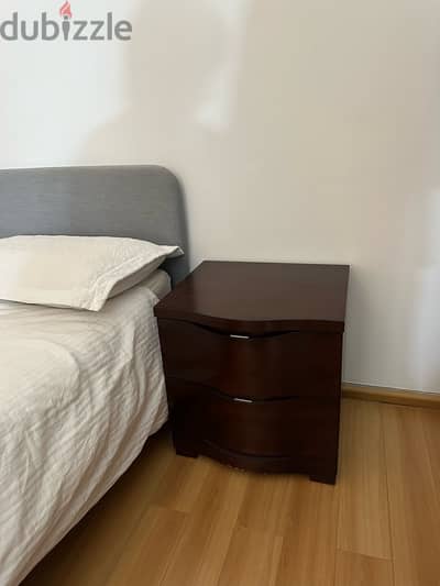 bed with mattress and one side table