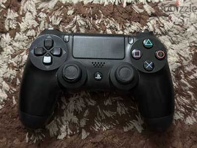 Two genuine Sony PlayStation 4 controllers and 2 games