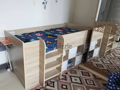 slightly used kid bunk bed with book storage