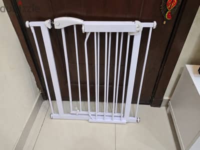 A stair gatebarrier used to block stairs or unsafe areas for babies