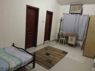 furnished room with attached bathroom