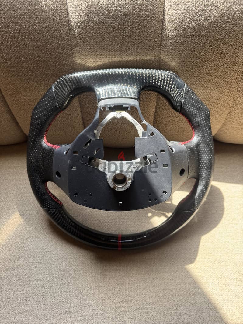 Carbon fiber sterring fits on lancer and pajero 65 bd fix price 1