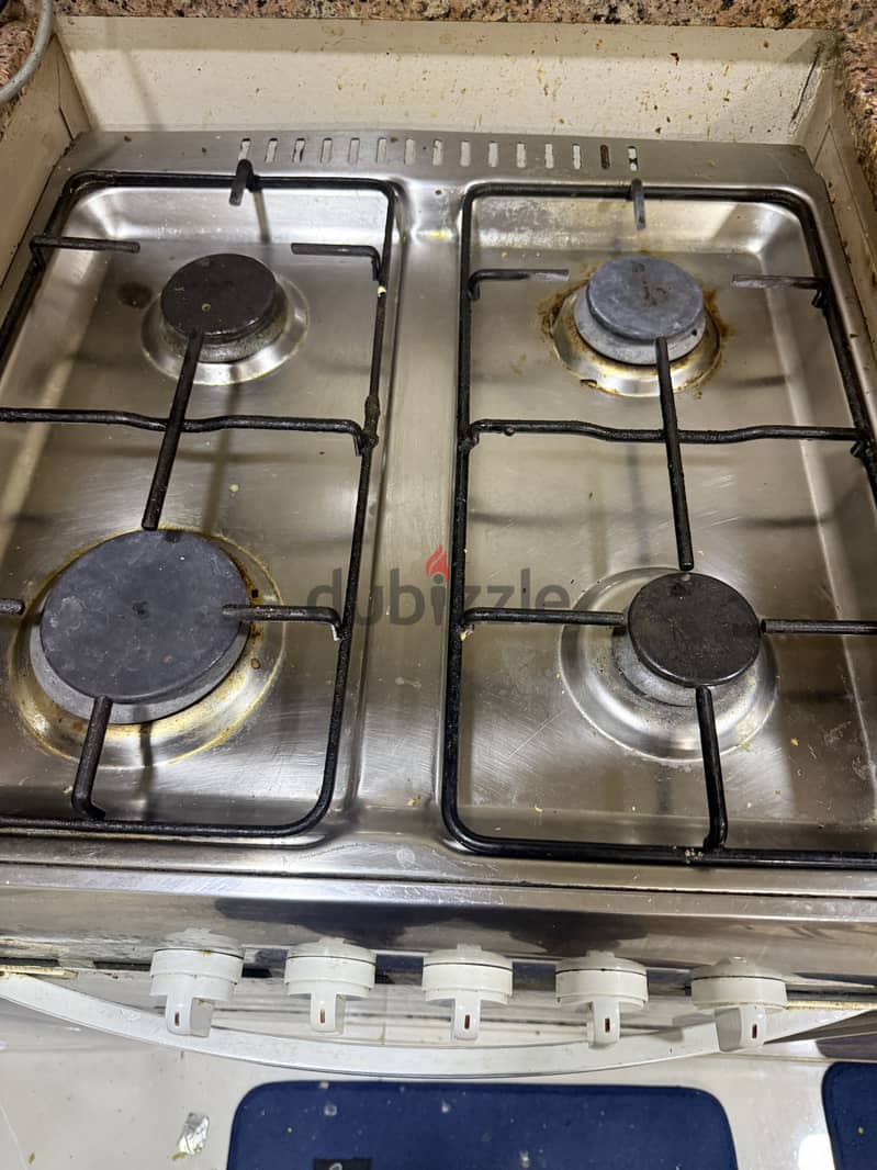 Cooking range, wardrobe, dining table for sale 1